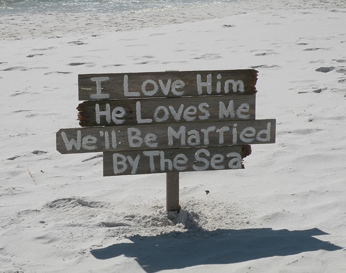 Image of wedding sign that read: I Love Him & He Loves Me. We'll Be Married by the Sea - Marry Me In Destin