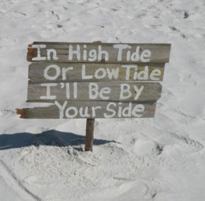 Image of wedding sign that read: In High Tide or In Low Tide, I'll Be By Your Side - Marry Me In Destin