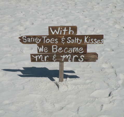 Image of ceremony sign that reads: With Sandy Toes & Salty Kisses We Became Mr. & Mrs. - Marry Me In Destin