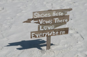 Image of ceremony sign that reads: Shoes Here, Vows There, LOVE Everywhere - Marry Me In Destin